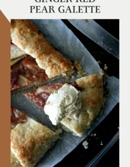 An overhead image of a sliced ginger pear galette with ice cream on a black sheet pan next to a knife and spoon.