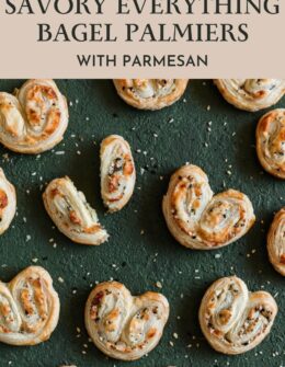 Rows of savory palmiers with everything bagel seasoning and parmesan on a dark green table.