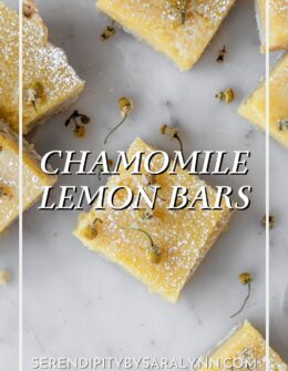 A closeup overhead image of randomly placed chamomile lemon bars on a white marble counter.