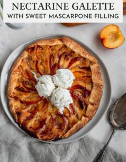 An overhead image of a mascarpone nectarine galette with three scoops of ice cream on a white marble counter next to a beige linen and vintage pie server.