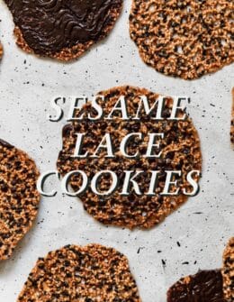 Sesame lace cookies in rows on a white counter.