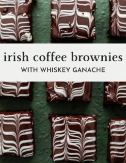 An overhead image of rows of Irish coffee brownies with chocolate and white chocolate swirl ganache on a dark green table.