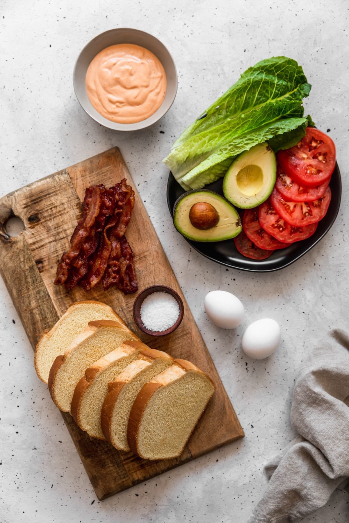 Open-Face Egg Sandwiches with Bacon, Avocado, & Sriracha Aioli