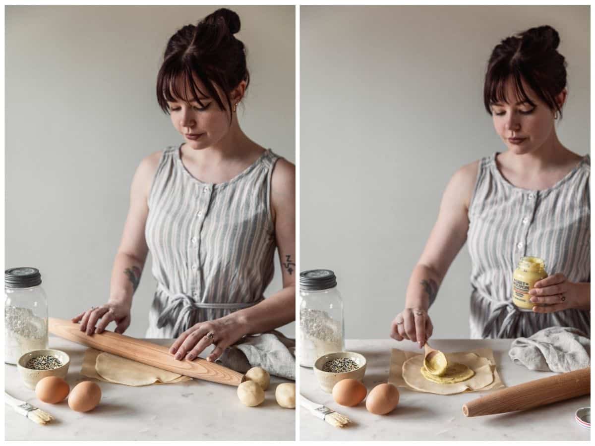 Two images; on the left, a woman wearing a grey and white striped dress is rolling pie dough on a marble counter next to a beige linen, eggs, more pie dough, and a jar of flour. On the right, the woman is spreading Dijon mustard onto the pie dough.