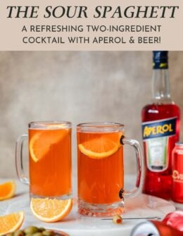 Two sour spaghett cocktails on a beige table next to a bottle of Aperol, cans of beer, and orange wedges.