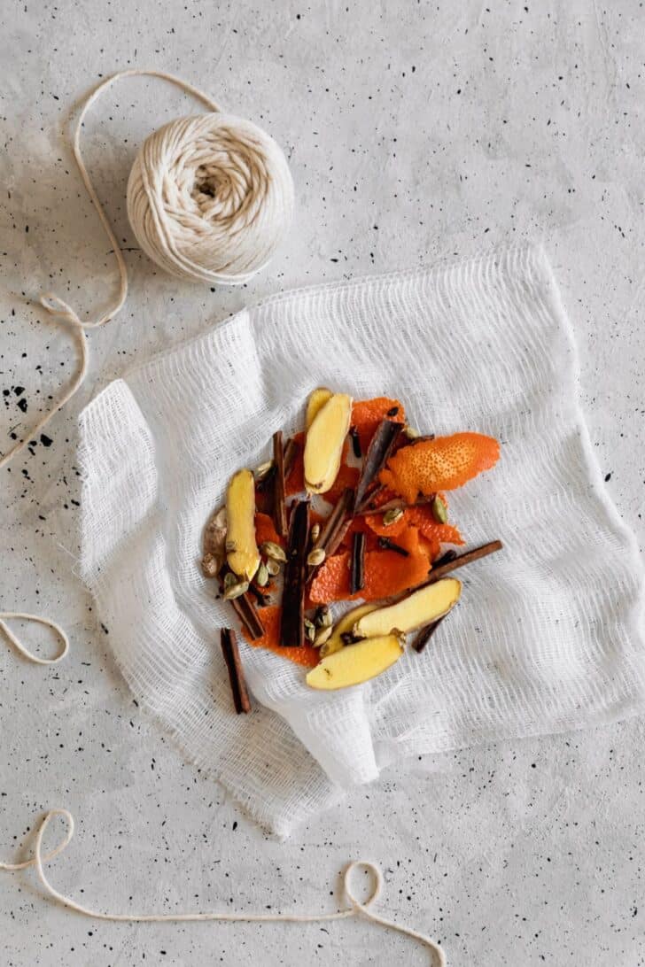 Cheese cloth with orange peels and spices in the center.
