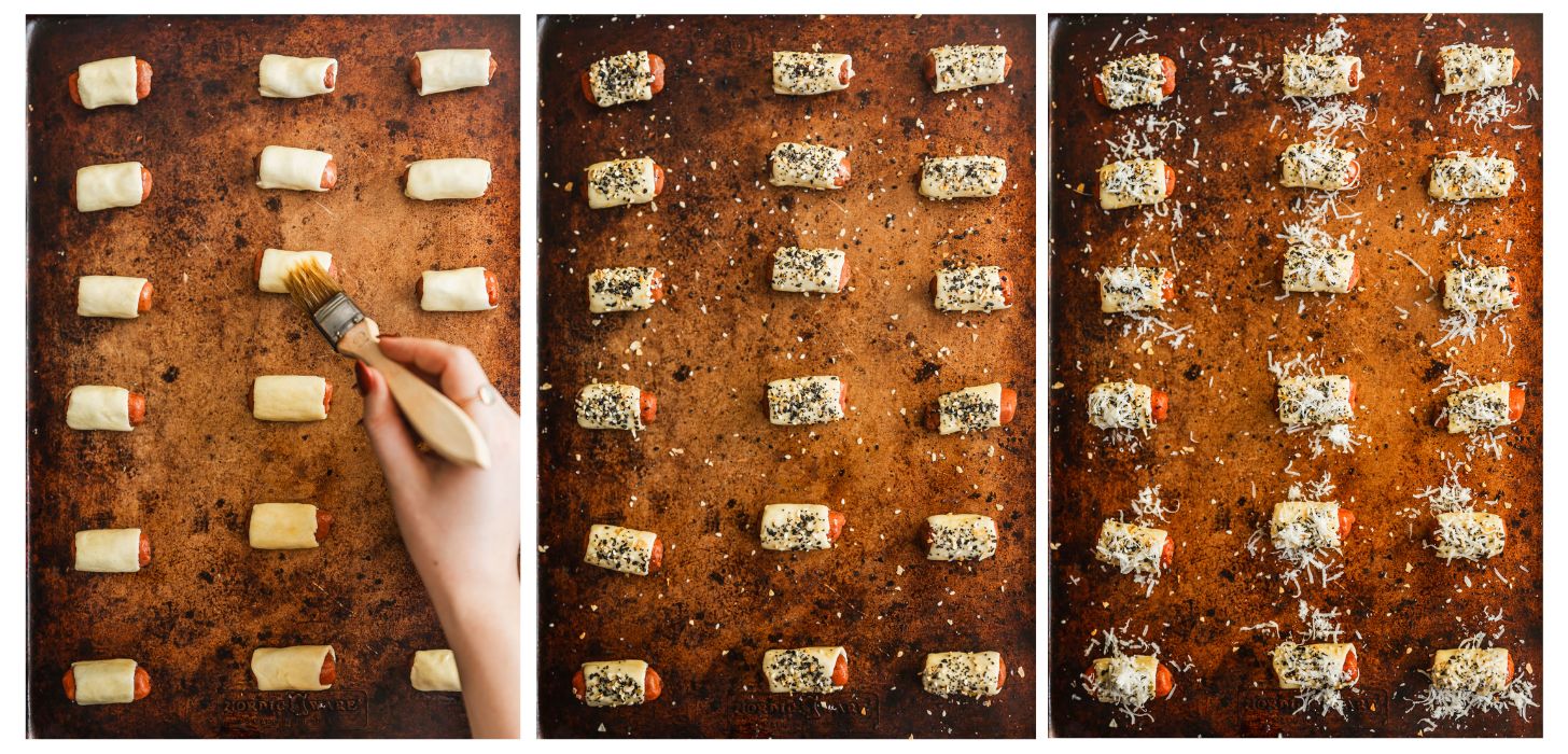 Three steps to making little smokies in a blanket. In photo 1, a hand brushes egg wash on rows of little smokies on a gold sheet pan. In photo 2, the smokies are covered in everything seasoning. In photo 3, the smokies have parmesan on top.
