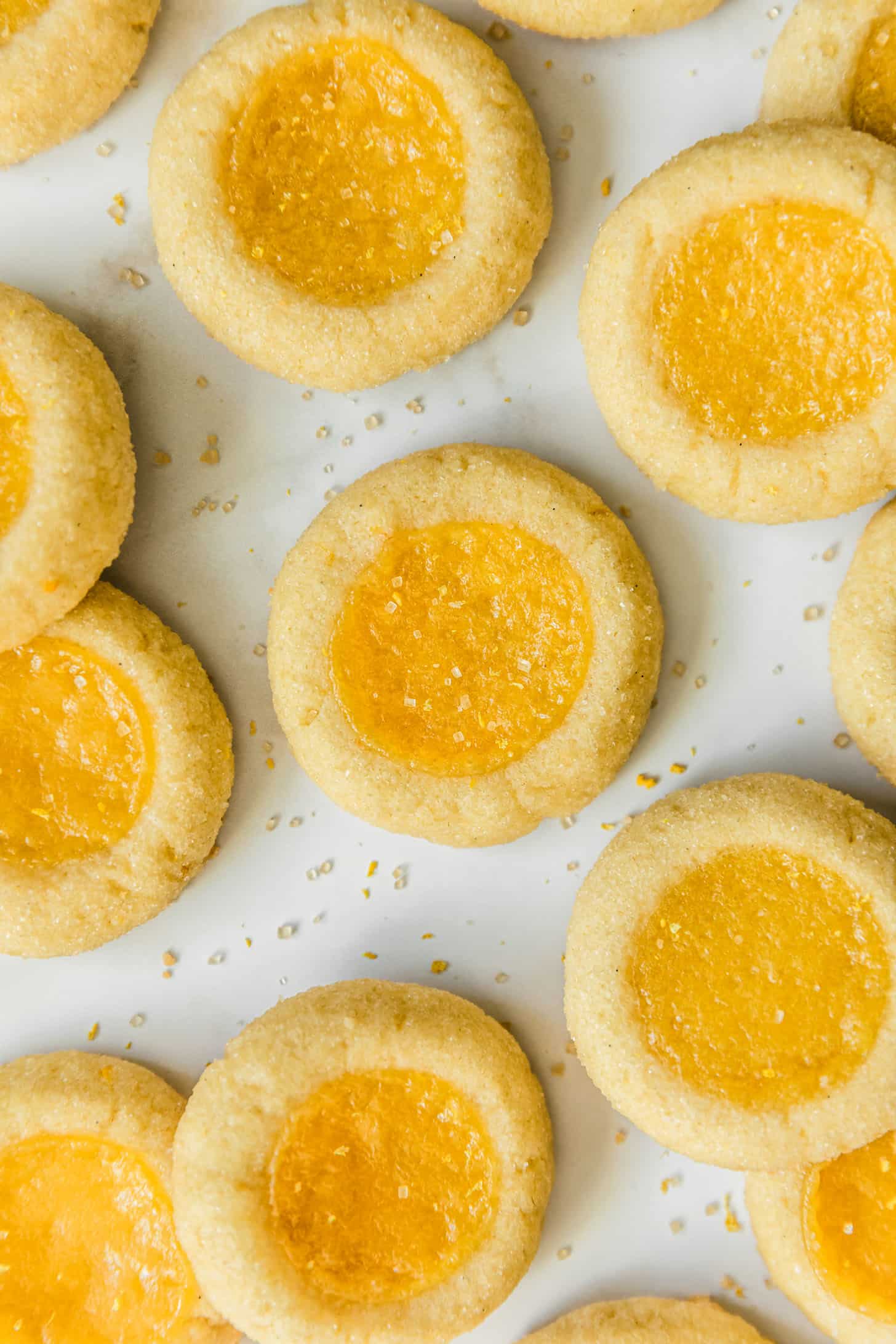 Rows of lemon curd cookies on a white background.