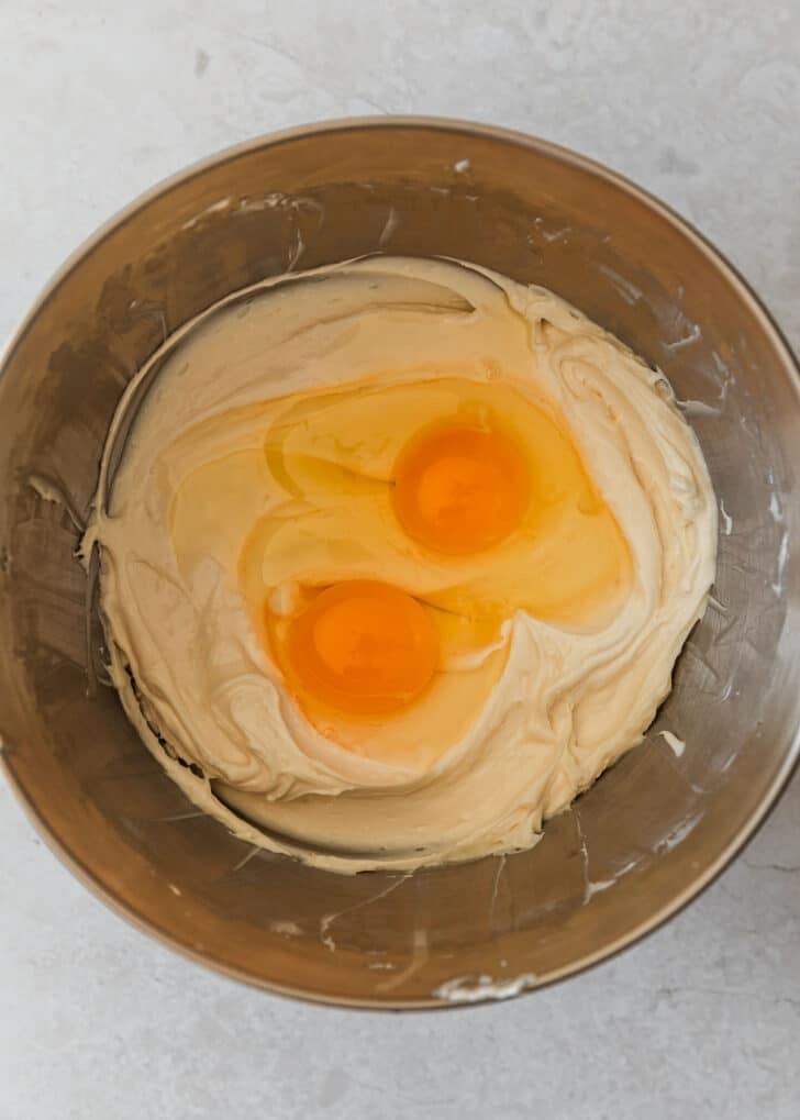 A silver bowl with cream cheese filling and eggs.