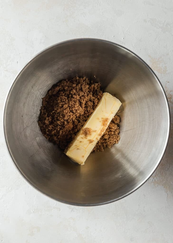 A silver bowl of butter and brown sugar on a tan counter.