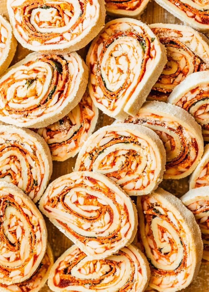 Piles of raw pizza scrolls.