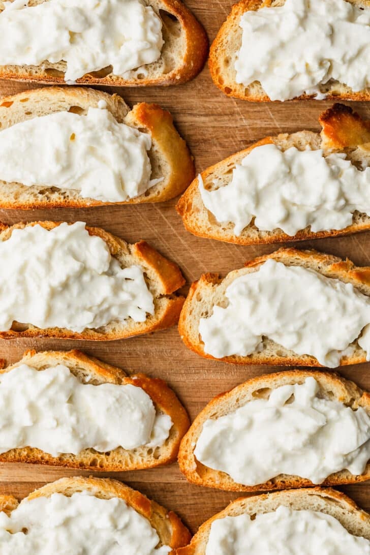 Rows of toasts topped with white cheese.