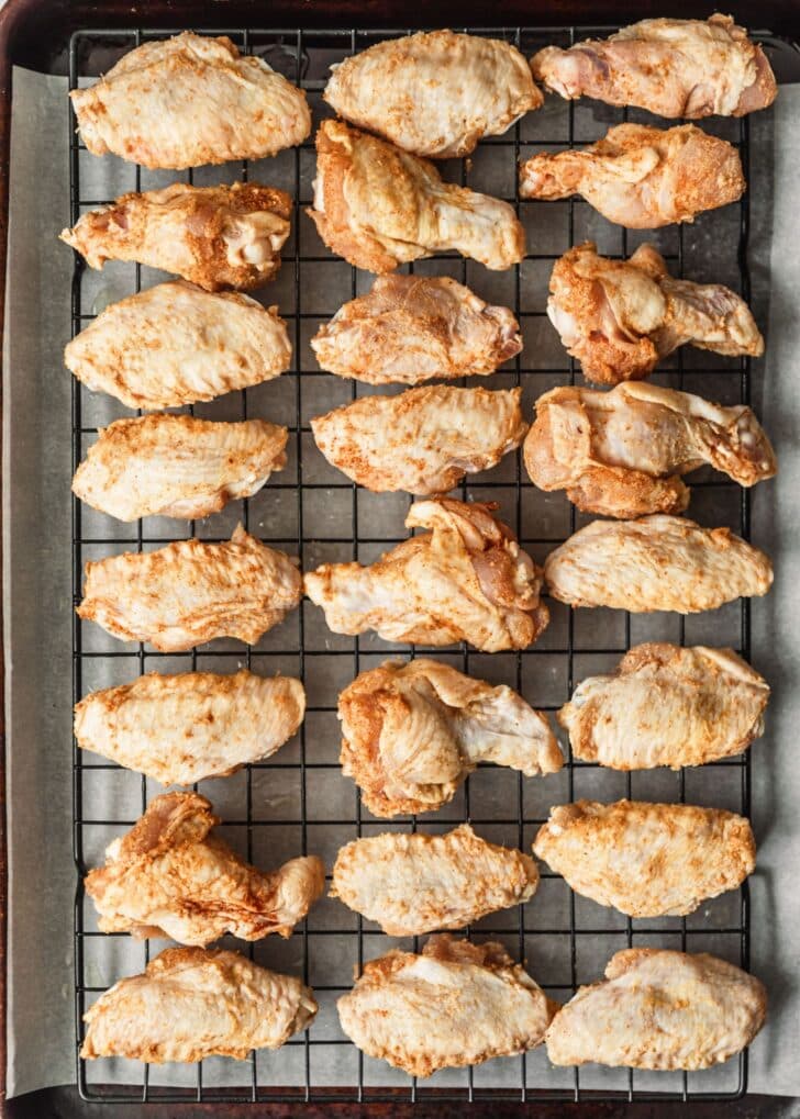 A wire rack of raw chicken.