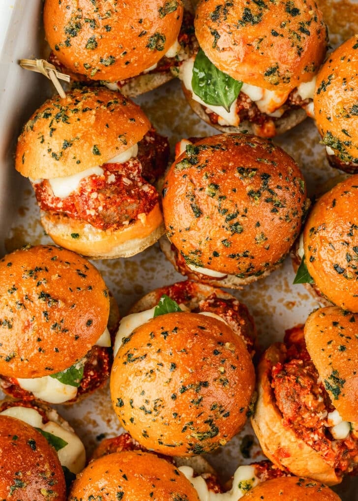 Italian meatball sliders in a white pan.