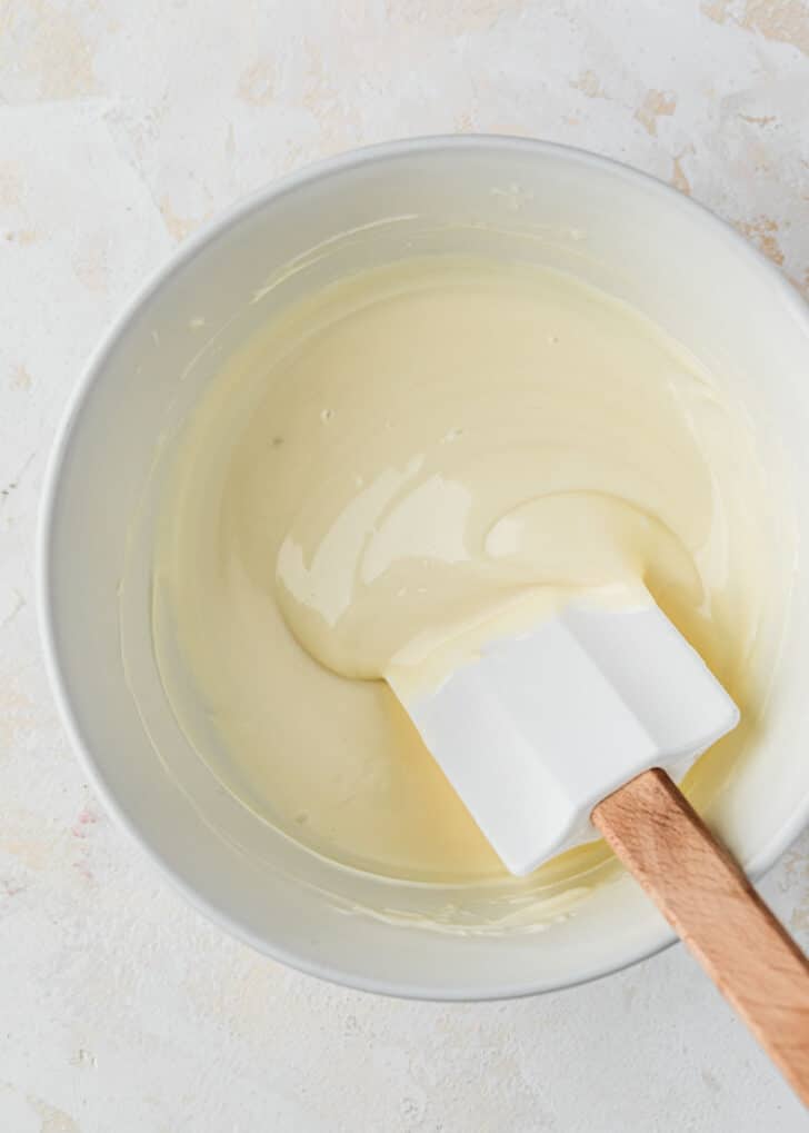 A white bowl of melted candy melts.