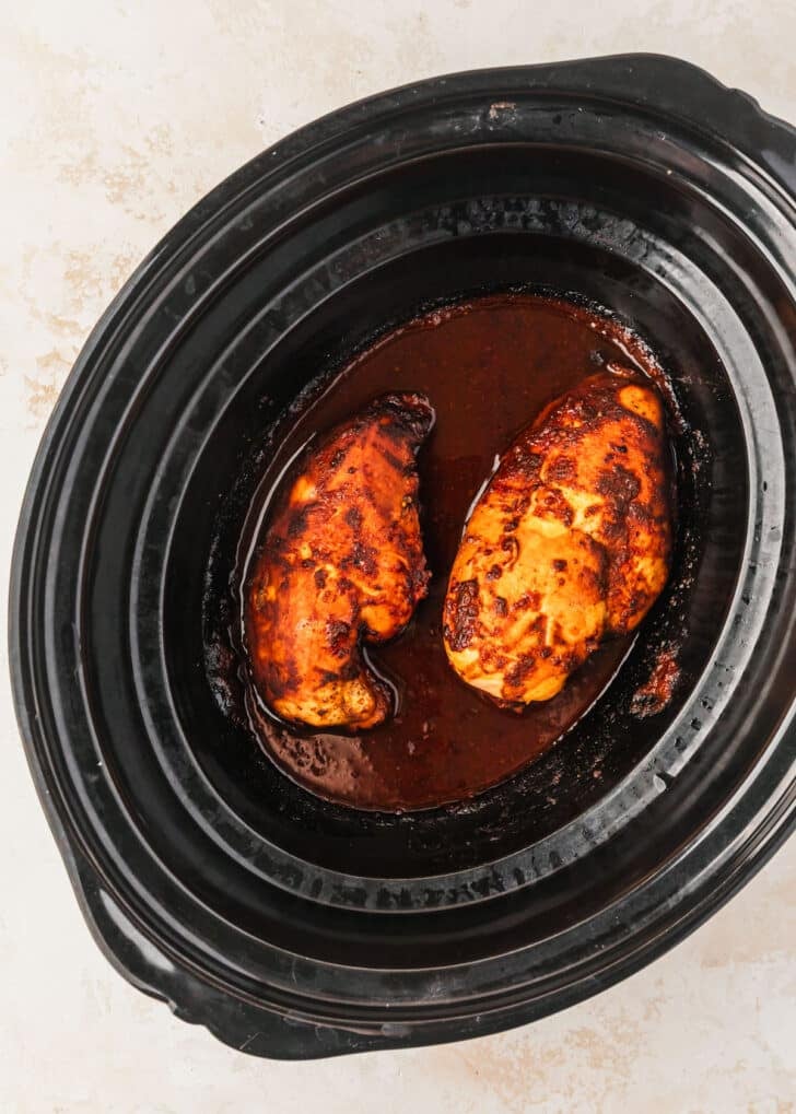 A slow cooker with BBQ chicken.
