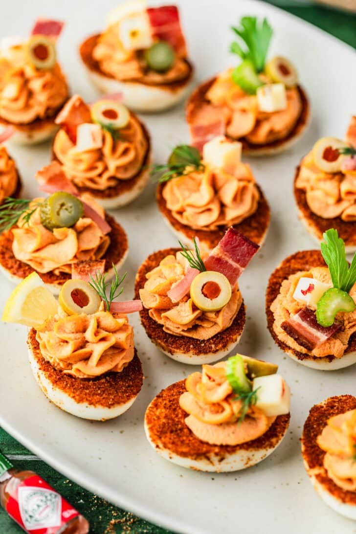 A white platter of Bloody Mary deviled eggs.