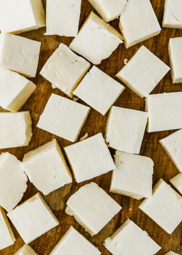 Cheese cubes on a wood board.