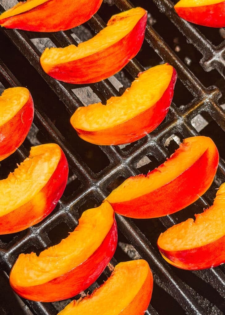 Peach slices on a grill.