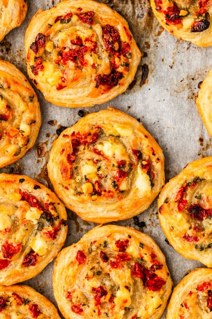 Baked sun-dried tomato and cheese pinwheels on puff pastry.