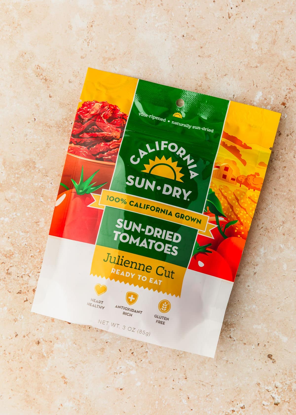 A package of sun-dried tomatoes on a tan counter.