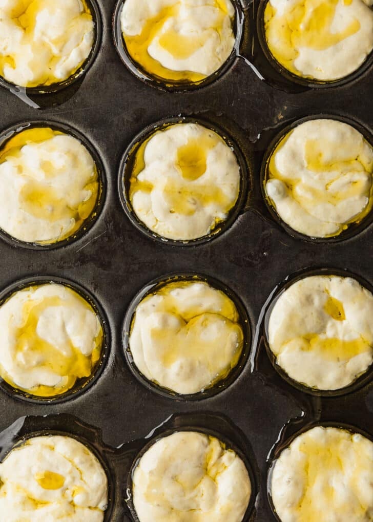 A cupcake pan filled with dough.