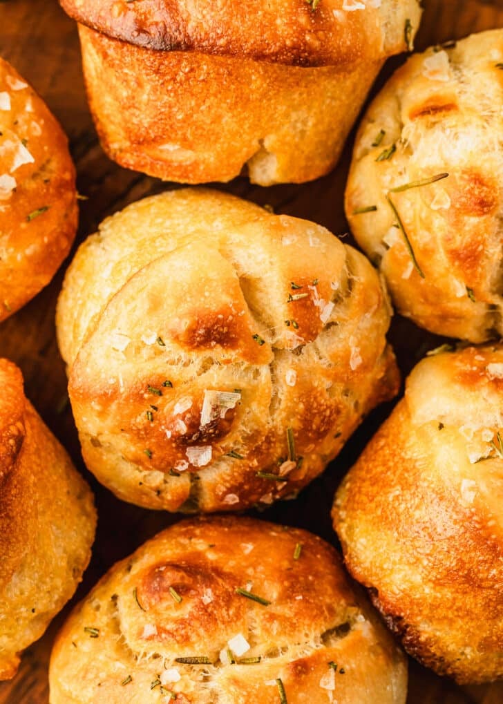 Rows of focaccia muffins with rosemary and salt.