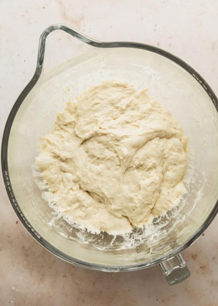 A clear bowl of dough for focaccia muffins after 16 stretch-and-folds.