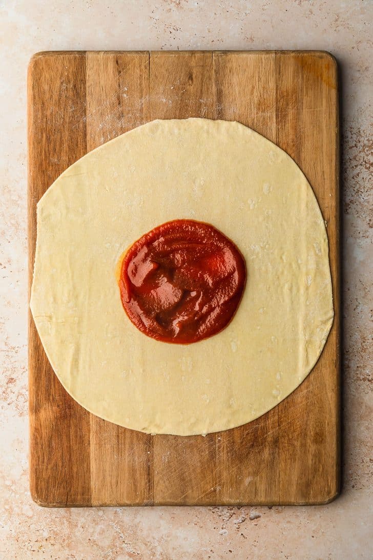 A circle of puff pastry with pumpkin butter in the center.